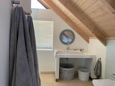 a bathroom with a sink and a mirror at Soul Place in Pringle Bay