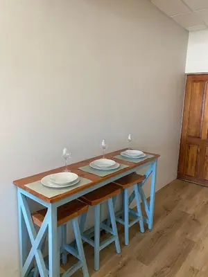 a blue table with three plates on top of it at Pistachio - Paarl - Self Catering Apartment in Paarl