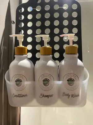 three bottles of laundry detergent sitting on a shelf at Pistachio - Paarl - Self Catering Apartment in Paarl