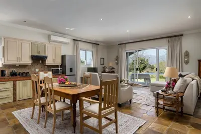 a kitchen and living room with a table and chairs at Bonne Chance Luxury Estate in Lynedoch