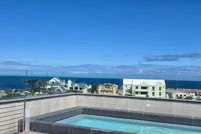 a swimming pool on the roof of a building at Whale Watchers studio in Hermanus
