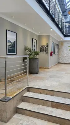 a lobby with stairs and a potted plant at Whale Watchers studio in Hermanus