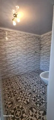 a bathroom with a tub and a toilet and a sink at Neo & Ruks Guest Houses Boston Belleville 6 in Bellville