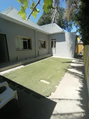 a house with a lawn in front of it at Neo & Ruks Guest Houses Boston Belleville 6 in Bellville