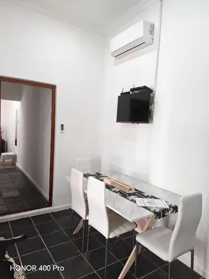 a dining room with a table and chairs and a mirror at Somerset west Stay 1 in Somerset West