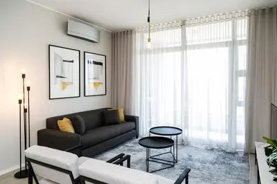 a living room with a couch and a table at Luxury Three Bedroom Axis- Ocean and Mountain Views in Cape Town