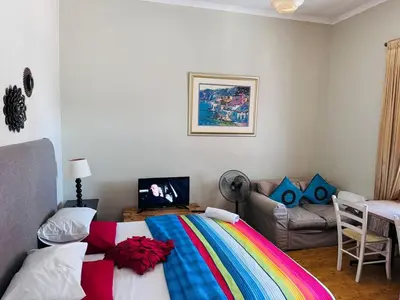 a bedroom with a bed with a colorful blanket at Peaceful getaway in Cape Town
