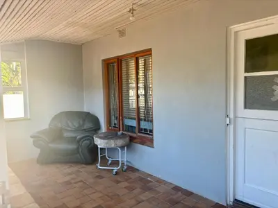 a living room with a chair and a window at One Bedroom House in Goodwood