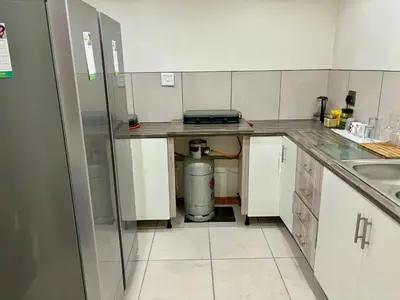 a small kitchen with a sink and a counter at One Bedroom House in Goodwood