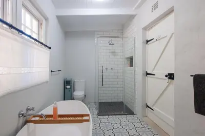 a bathroom with a tub and a shower and a toilet at Serendipity Self-Catering Cottage in Greyton