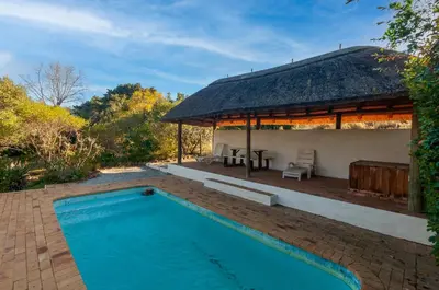 a house with a swimming pool and a pavilion at Serendipity Self-Catering Cottage in Greyton