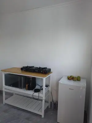 a table with a stove and a refrigerator in a room at 60 On Kosmos in Bellville South