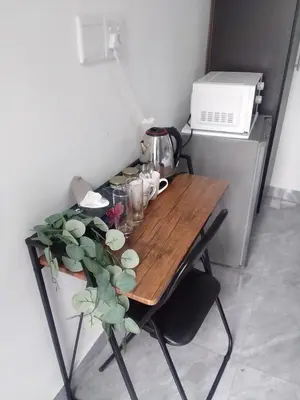 a wooden table with a plant on top of it at 60 On Kosmos in Bellville South