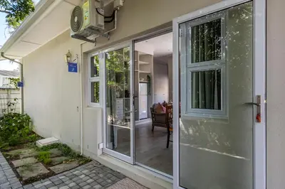 an entrance to a home with sliding glass doors at Twelve on Arum in Somerset West