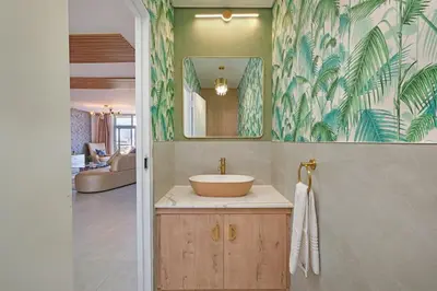 a bathroom with a sink and a mirror at Ultra Luxury 3 Bed Knightsbridge Penthouse in Cape Town
