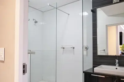 a bathroom with a glass shower and a sink at 126 Andringa Walk in Stellenbosch