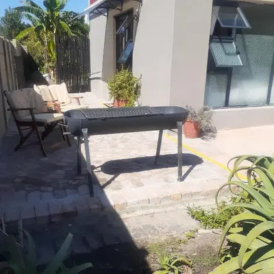 a black ping pong table sitting on a patio at Rosa Villa in Hermanus