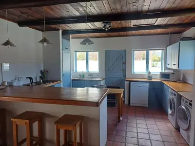 a large kitchen with a counter and a sink at Holiday Vibe in Hermanus
