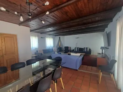 a living room with a couch and a table and chairs at Holiday Vibe in Hermanus