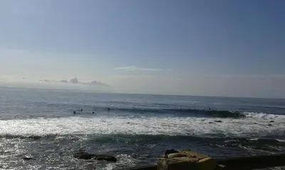 a group of people in the water at the beach at PROVIDENCE VILLA -Tranquil, Neat & Private Cottage in Hermanus