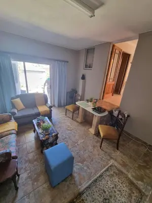 a living room with a couch and a table at UITZICHT STAY Durbanville Pet Friendly in Oakdale