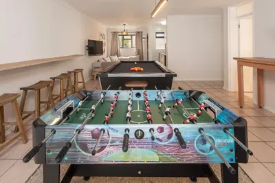 a pool table in the middle of a room at Fun in the Voelklip Sun in Hermanus