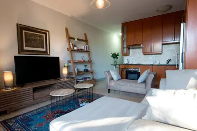 a living room with a couch and a tv at Oude Hoek, Stellenbosch Central in Stellenbosch