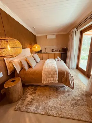 a bedroom with a large bed and a large window at Self Check-in River View Suite in Wellington