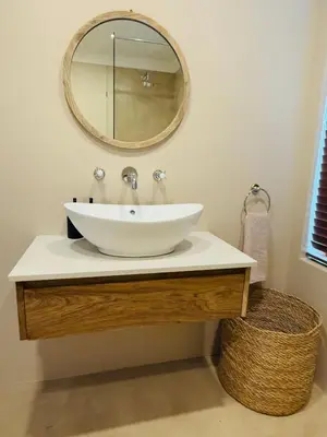 a bathroom sink with a large mirror on the wall at Self Check-in River View Suite in Wellington