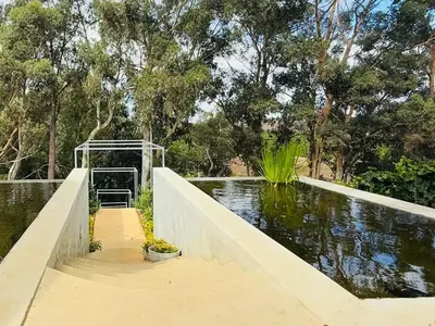 a bridge over a pond in a park at Self Check-in River View Suite in Wellington