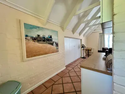 a living room with a painting on the wall at The Loft House in Cape Town