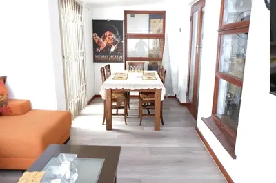 a living room with a table and a couch at Villa on Flamingo Vlei in Cape Town