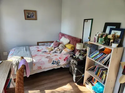 a bedroom with a bed with stuffed animals on it at St James home in Somerset West