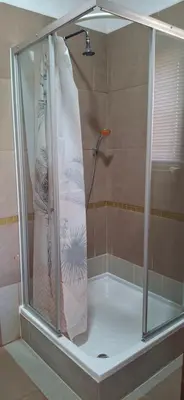 a shower with a shower curtain in a bathroom at Arendsnest Self Catering in Gordonʼs Bay