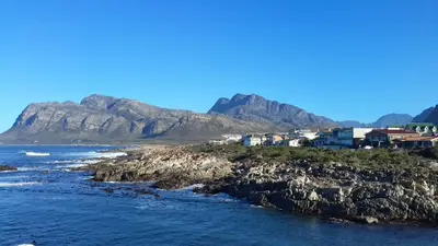 a view of the ocean with mountains in the background at La Mer Seafront Selfcatering Accommodation Kleinmond in Kleinmond