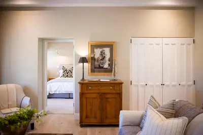a living room with a bedroom with a bed at Grande Provence in Franschhoek