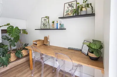 a dining room table with chairs and plants at Studio 98 - 300m from cliff path in Hermanus