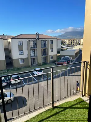 a balcony with a view of a parking lot at Beautiful 2 bedroom apartment in strand in Somerset West