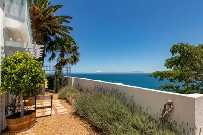 a house with a view of the ocean at Whale Watchers Gordons Bay in Gordonʼs Bay