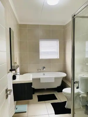 a bathroom with a tub and a toilet at Altin Pearl Luxury Apartment in Cape Town