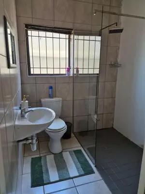 a bathroom with a toilet and a sink and a shower at ESME's REST in Cape Town
