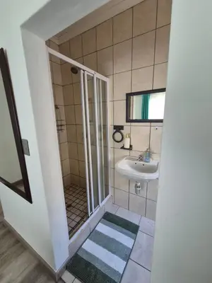 a bathroom with a shower and a sink at ESME's REST in Cape Town
