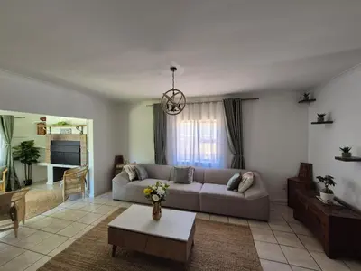a living room with a couch and a table at ESME's REST in Cape Town
