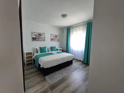 a bedroom with a bed and a large window at ESME's REST in Cape Town