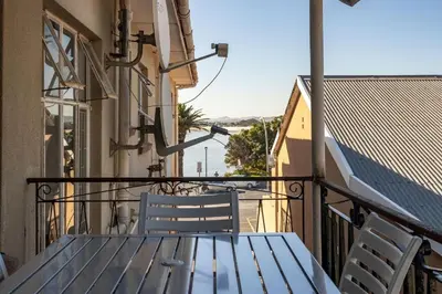 a blue table and chairs on a balcony at Tweede Boom in Cape Town