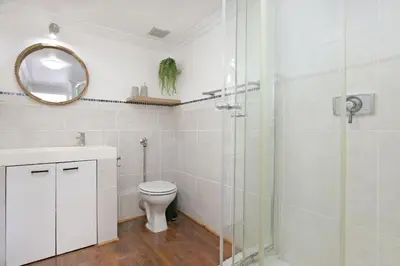 a bathroom with a toilet and a glass shower at Gordonia 10 in Cape Town