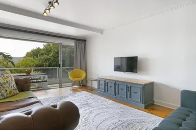a living room with a couch and a television at Gordonia 10 in Cape Town