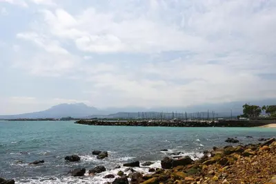 a beach with a rocky shoreline and the ocean at Gordonia 10 in Cape Town