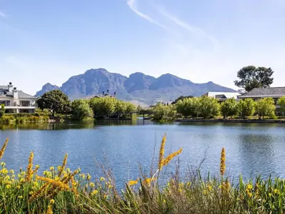 a view of a lake with mountains in the background at Luxury Lodge 5B, Pearl Valley Golf Estate in Simondium