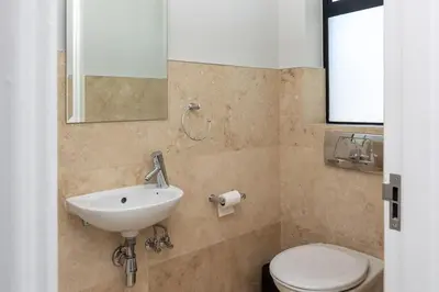 a bathroom with a sink and a toilet at Luxury Lodge 5B, Pearl Valley Golf Estate in Simondium